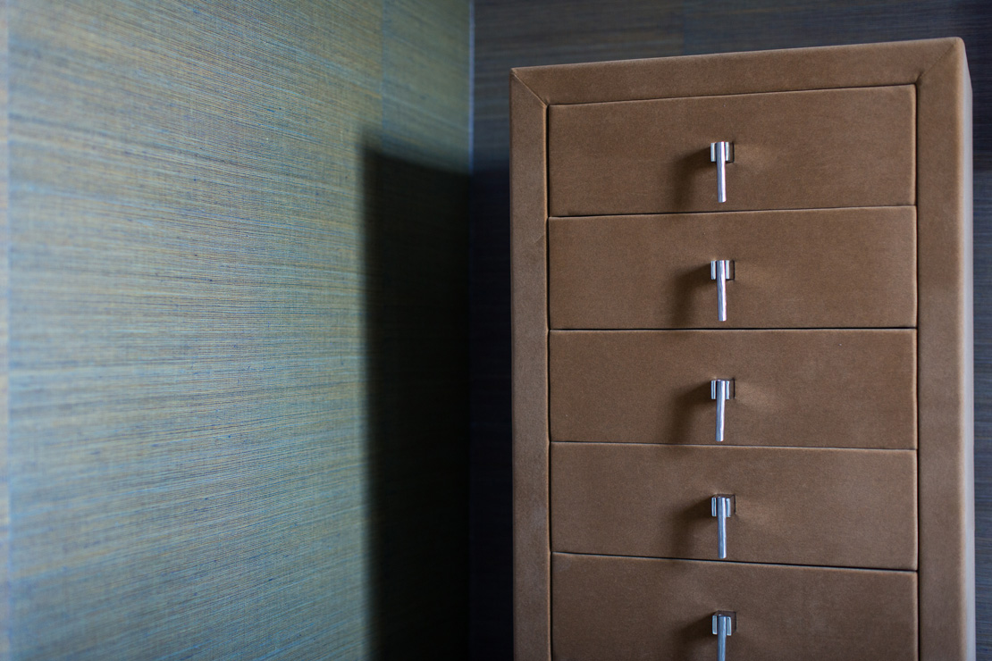 Chest of drawers covered in suede,  in an office with starw wallpaper from elitis