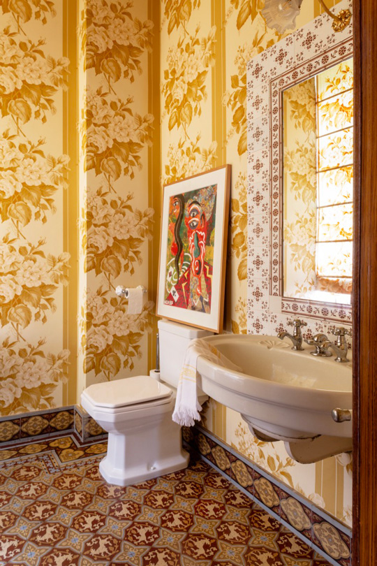 Antic bathroom in a castle with Yellow wallpaper and with antic bathroom sink